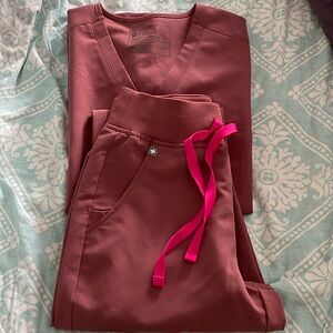 Figs uniform. Beautiful mineral mauve color. NWT too small for me. Never used